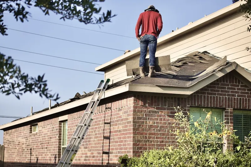 Professional roofer working on a residential roof in Timberlane